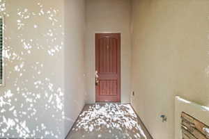 Entrance to property with stucco siding