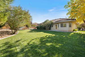 Rear view of house featuring stucco siding, a patio, and a tiled roof