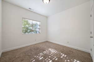 Carpeted empty room with baseboards