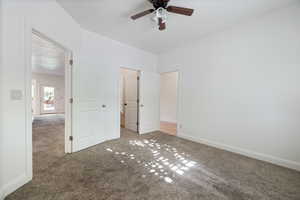 Unfurnished bedroom featuring carpet and ceiling fan