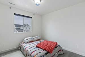 Carpeted bedroom featuring baseboards
