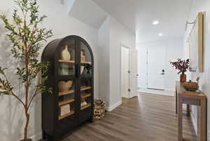 Hallway featuring wood finished floors and recessed lighting