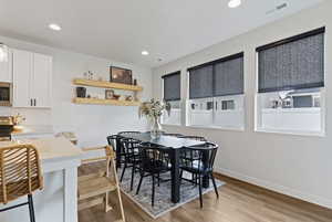 Dining space featuring light wood-type flooring and recessed lighting
