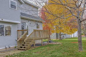View of green lawn with a wooden deck