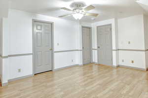 Unfurnished room featuring light wood-style flooring and ceiling fan