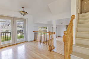 Stairway featuring wood finished floors and baseboards