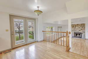 Interior space featuring light wood finished floors and an upstairs landing