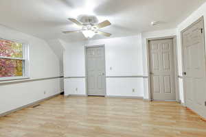 Additional living space featuring light wood-style floors, a ceiling fan, and a textured ceiling