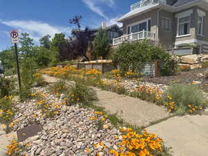View of side of home with stucco siding and a balcony