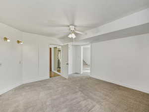 Empty room featuring ceiling fan and carpet