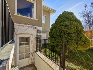 Doorway to property featuring stucco siding