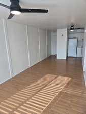 Unfurnished living room with a ceiling fan and light wood-style floors