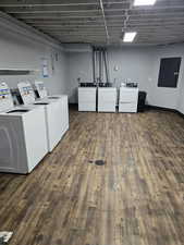 Laundry area with washing machine and clothes dryer and electric panel