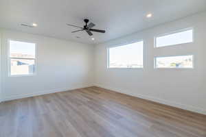 Unfurnished room with light wood-style floors, a ceiling fan, and recessed lighting