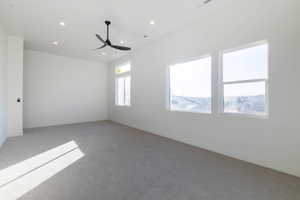 Carpeted spare room featuring recessed lighting and ceiling fan