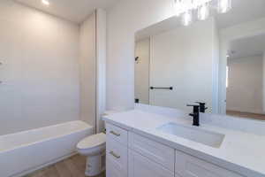 Full bath with light wood-style floors, vanity, recessed lighting, and tub / shower combination