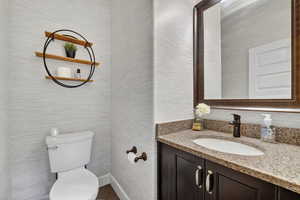 Bathroom featuring vanity and toilet