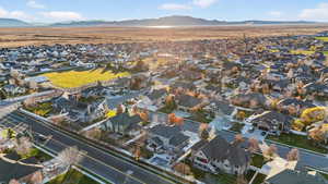 Aerial overview of property's location with nearby suburban area and a mountainous background
