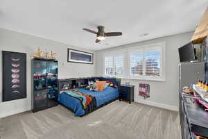 Bedroom featuring light carpet and a ceiling fan