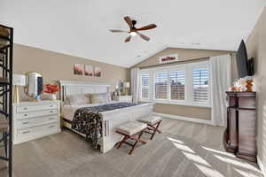 Bedroom featuring lofted ceiling, light colored carpet, and ceiling fan