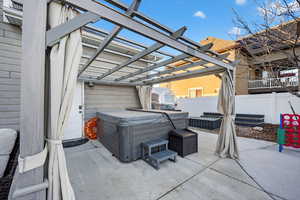 View of patio featuring a pergola and a hot tub