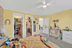 Bedroom with crown molding, light carpet, and a ceiling fan