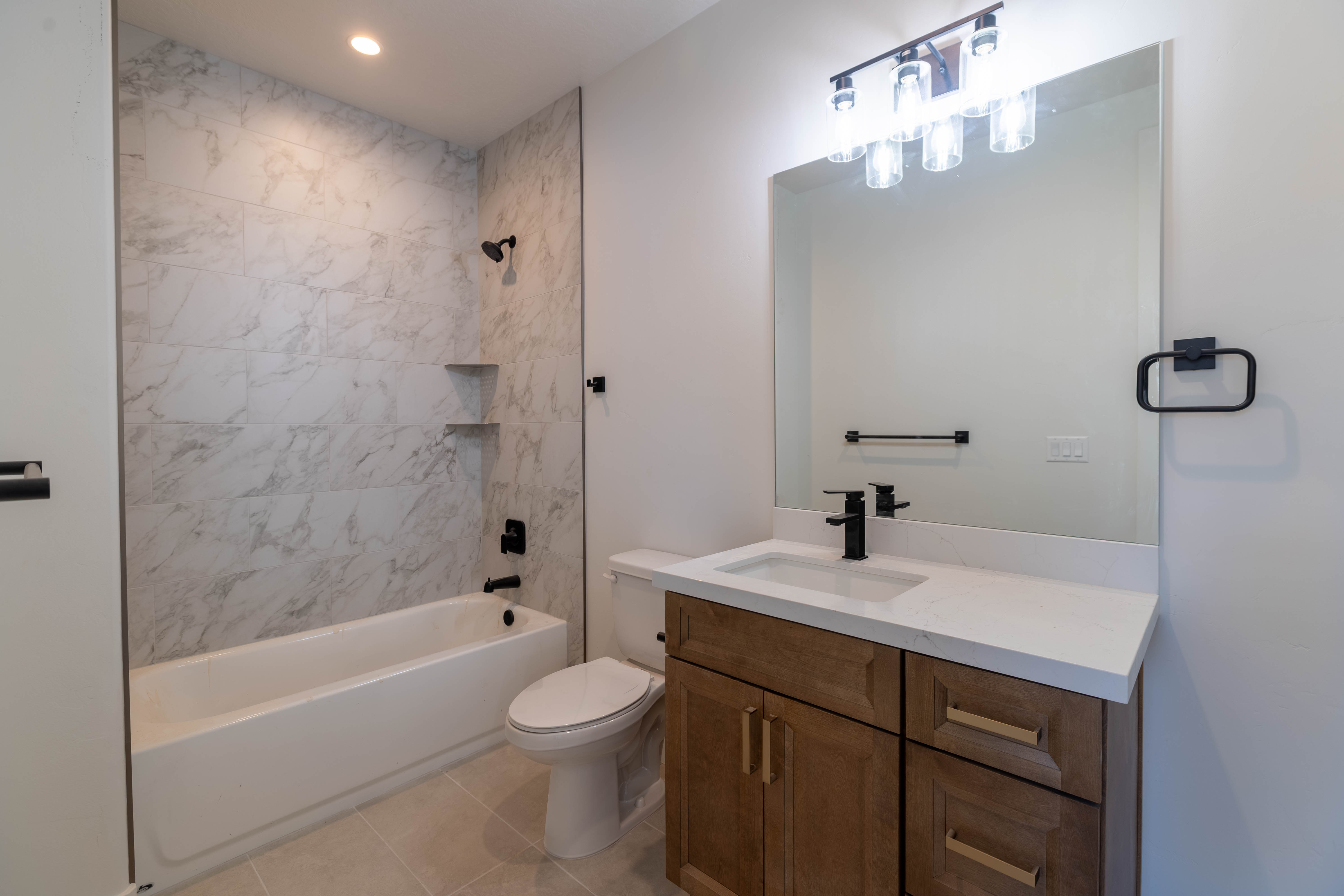 Full bathroom featuring bathing tub / shower combination, vanity, light tile patterned flooring, and recessed lighting