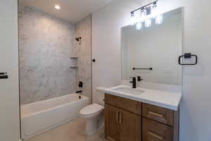 Full bathroom featuring bathing tub / shower combination, vanity, light tile patterned flooring, and recessed lighting