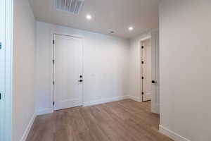 Unfurnished room featuring light wood-style floors and recessed lighting