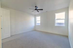 Spare room with carpet flooring and ceiling fan