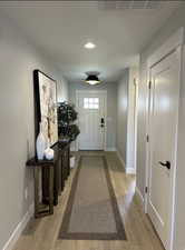 Entryway featuring hardwood / wood-style floors and recessed lighting