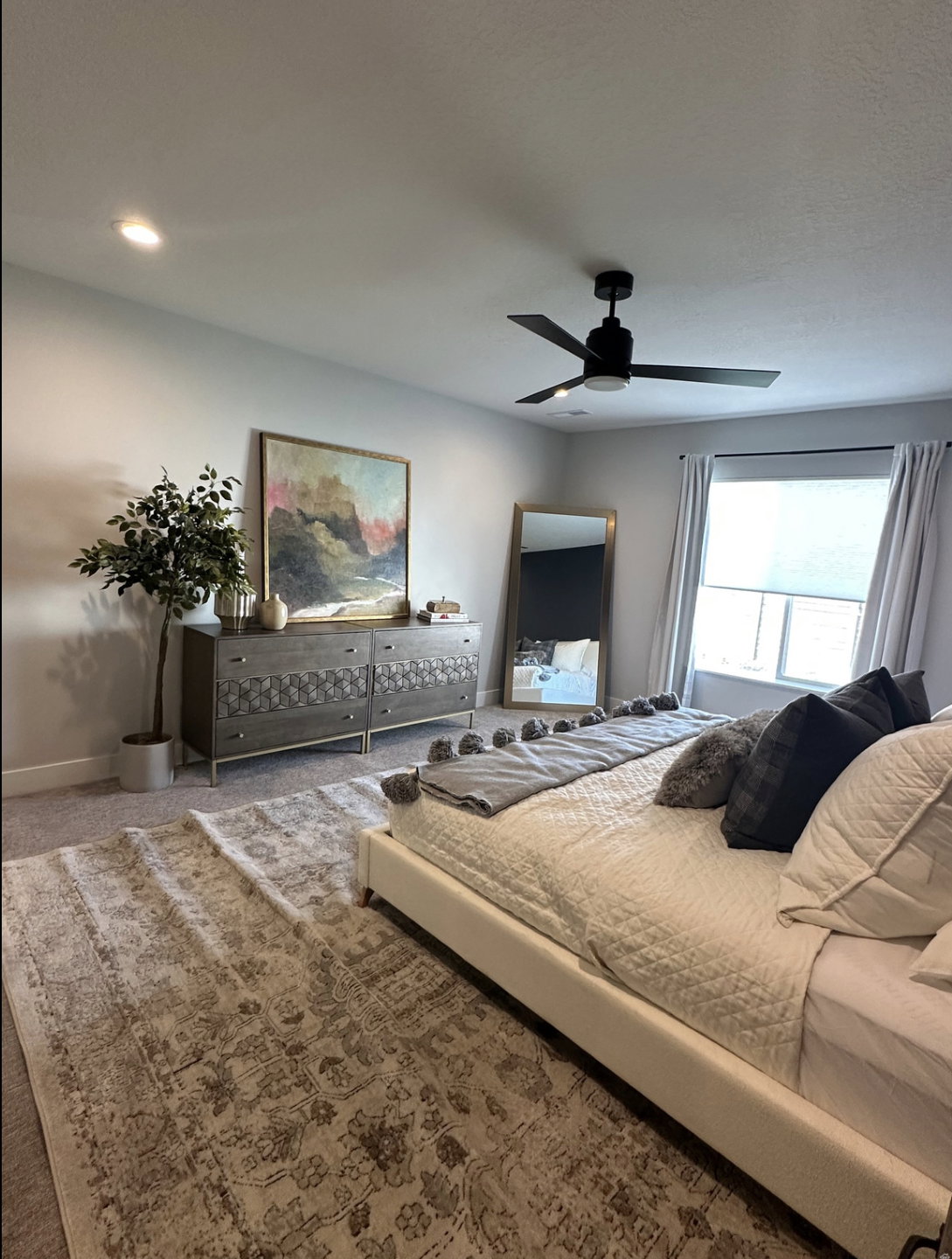 Carpeted bedroom featuring a ceiling fan and recessed lighting