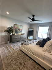 Carpeted bedroom featuring a ceiling fan and recessed lighting