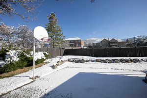 View of sport court featuring a fenced backyard and a residential view