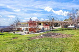 View of front of house featuring a front yard and brick siding