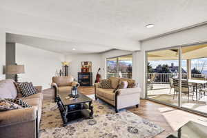 Living room with wood finished floors, recessed lighting, and a textured ceiling