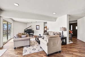 Living area featuring plenty of natural light, wood finished floors, and recessed lighting