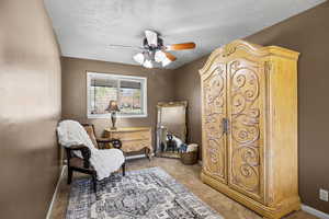 Master Bedroom Sitting room featuring carpet floors, a textured ceiling, and ceiling fan