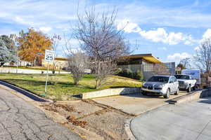 View of front of property featuring a front yard and driveway