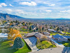 Aerial perspective of suburban area featuring a mountain backdrop