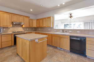 Kitchen featuring black appliances, tile countertops, backsplash, ceiling fan, and recessed lighting