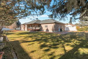Rear view of property with brick siding and a shingled roof