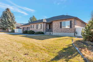 Ranch-style house with brick siding, a garage, and a gate