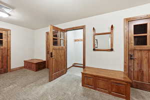 Unfurnished bedroom featuring carpet floors and baseboards