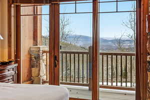 Bedroom featuring a mountain view and multiple windows