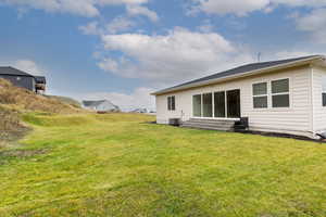 Back of house featuring a lawn