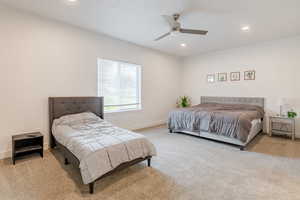 Bedroom featuring light carpet, ceiling fan, and recessed lighting