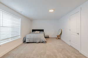 Carpeted bedroom featuring baseboards