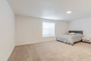 Carpeted bedroom with baseboards