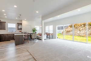 Living area featuring light wood-type flooring and recessed lighting
